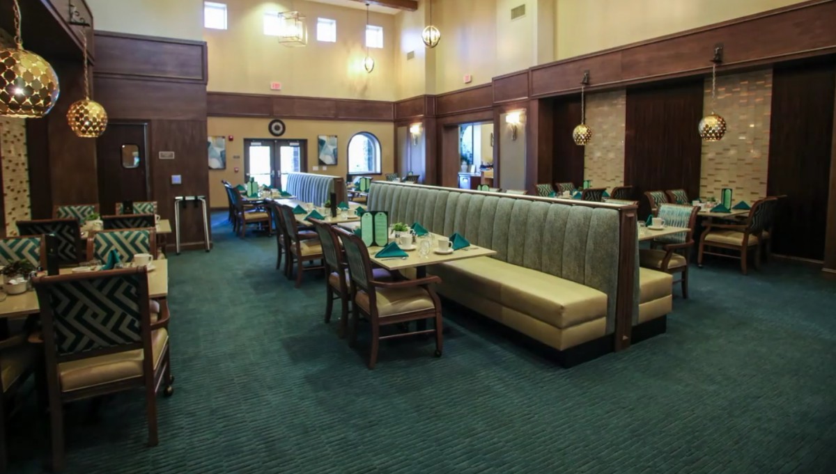 A spacious restaurant interior with neatly arranged tables and chairs.