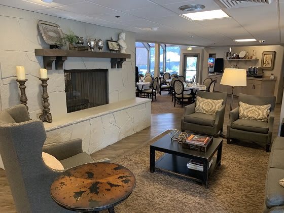 Cozy and inviting living room with a fireplace and comfortable seating.