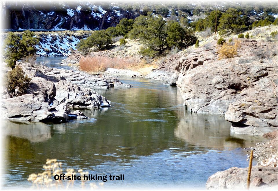 A serene view of a river flowing through rocky terrain on an off-site biking trail.