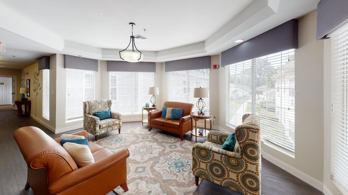 A cozy and bright living room with comfortable seating, large windows, and elegant decor.