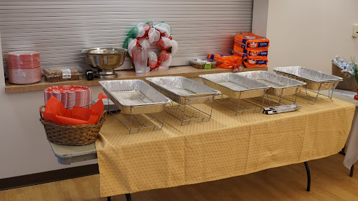 An organized catering setup with serving trays and decorative elements for an event.