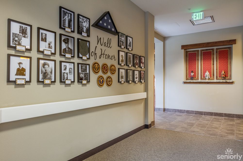 A hallway featuring a Wall of Honor with photographs and military decorations.