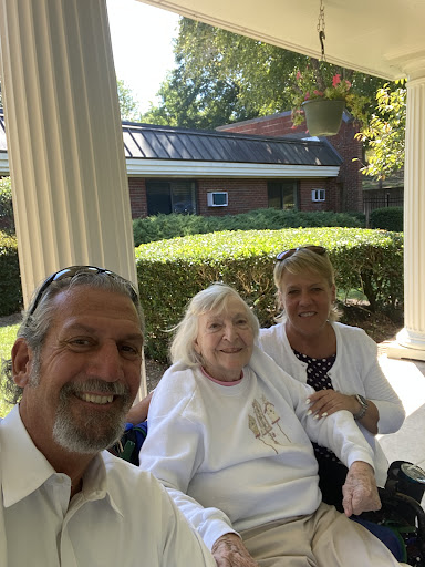A joyful moment shared among family members outside.