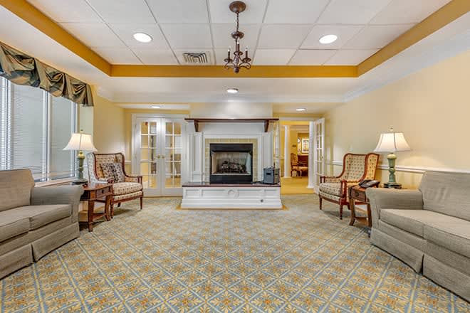 A luxurious living room with elegant furniture and a fireplace, showcasing intricate interior design.