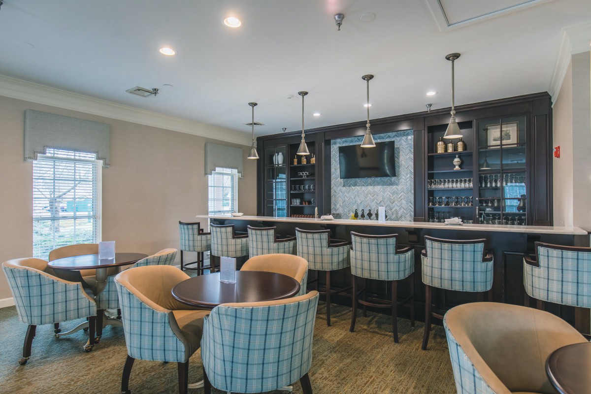 A modern bar and seating area with stylish interior design and cozy seating.