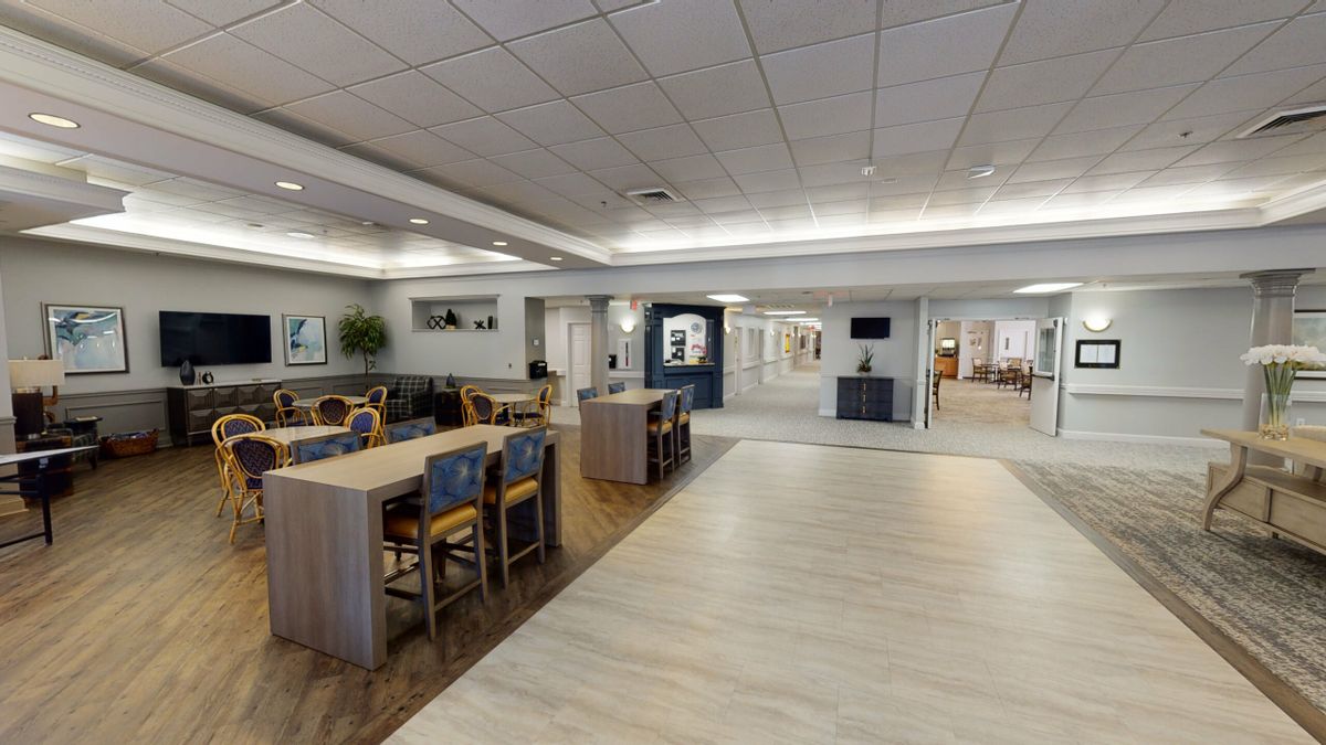 A modern and spacious dining area with tables and chairs arranged neatly.