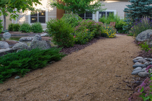 A beautifully landscaped garden pathway leading to a home.