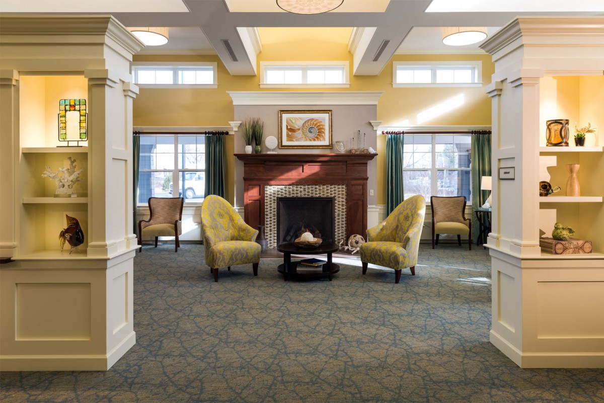 A cozy living room with a central fireplace and comfortable seating.