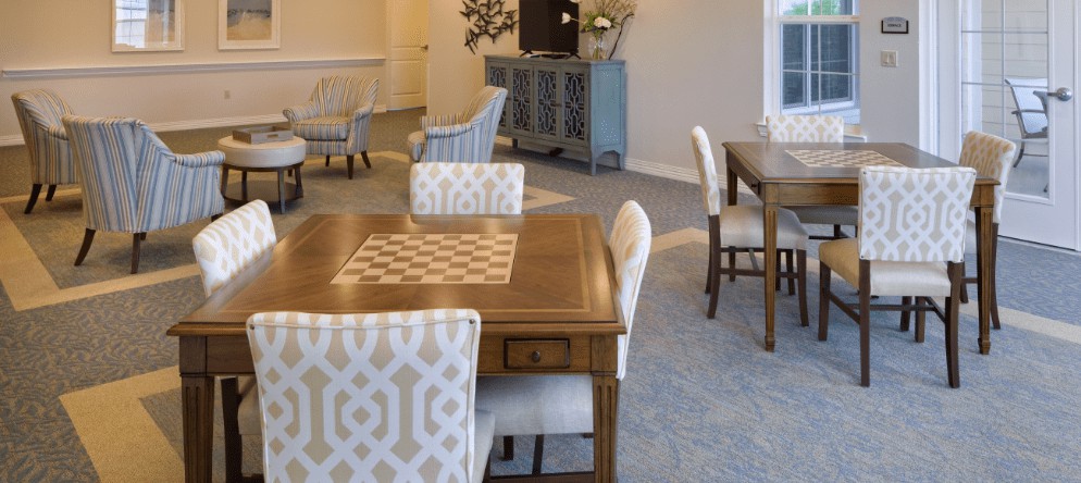 A modern dining area with stylish chairs and a wooden table in a well-decorated living space.