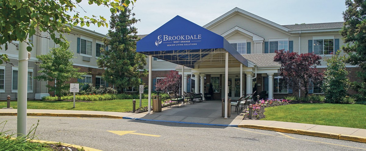 The entrance of a Brookdale retirement home featuring an awning.