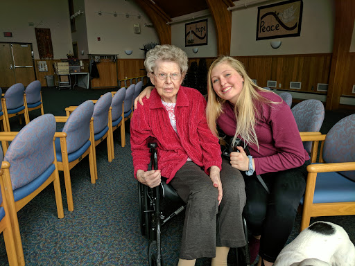 A heartwarming moment shared between a young woman and an elderly lady.