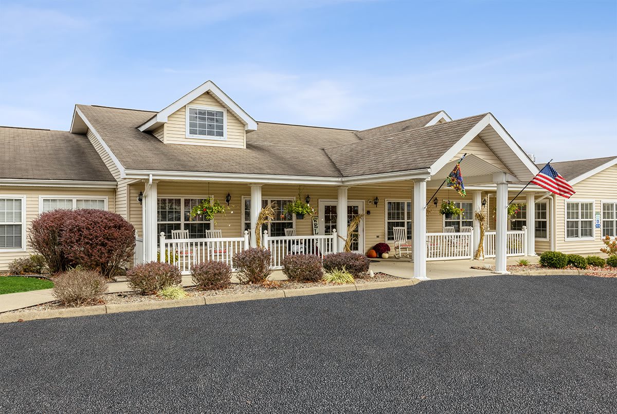 A charming suburban home with a welcoming porch and well-maintained landscaping.