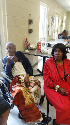 Two elderly women enjoying time together in a community setting.