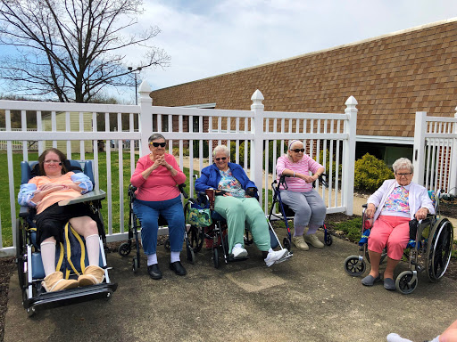Seniors enjoying a sunny day outdoors in their wheelchairs, fostering community and connection.