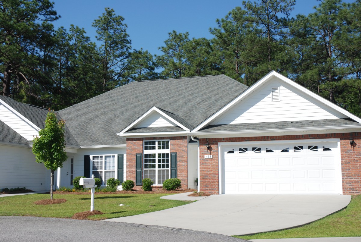 A suburban house with a well-maintained front yard and attached garage.