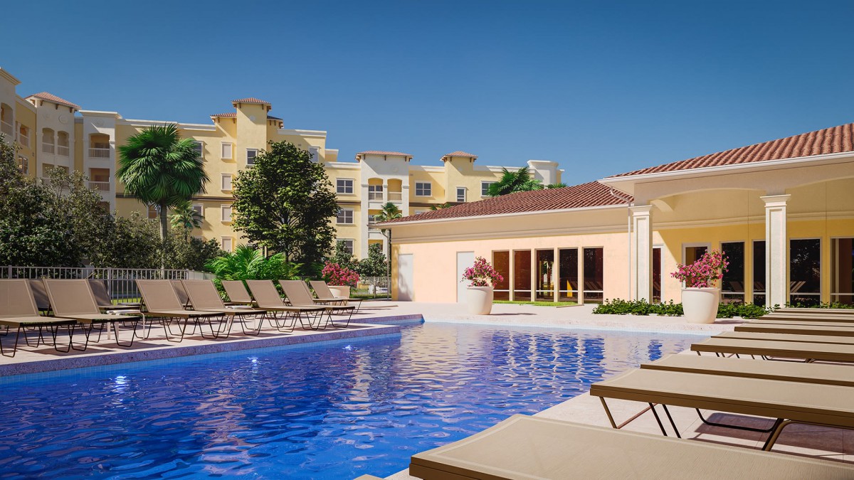 Luxurious resort pool with lounge chairs under a clear blue sky.