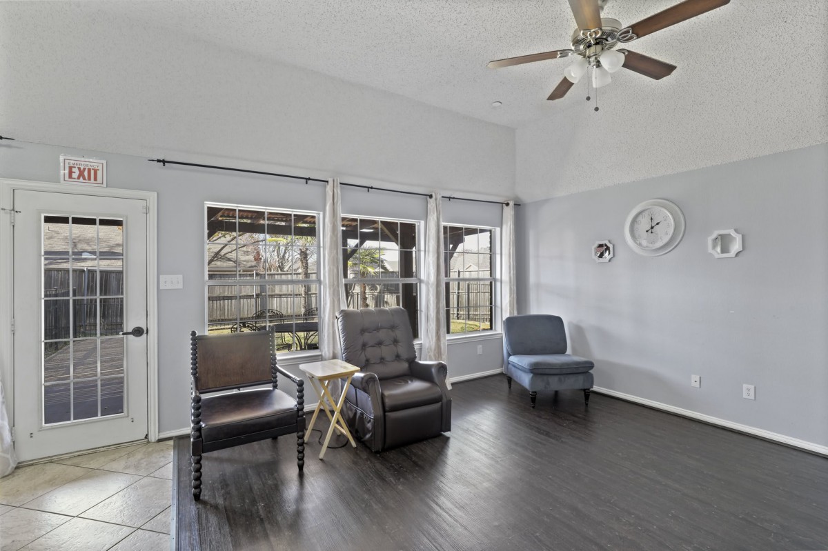 A spacious living room with modern furnishings and large windows.