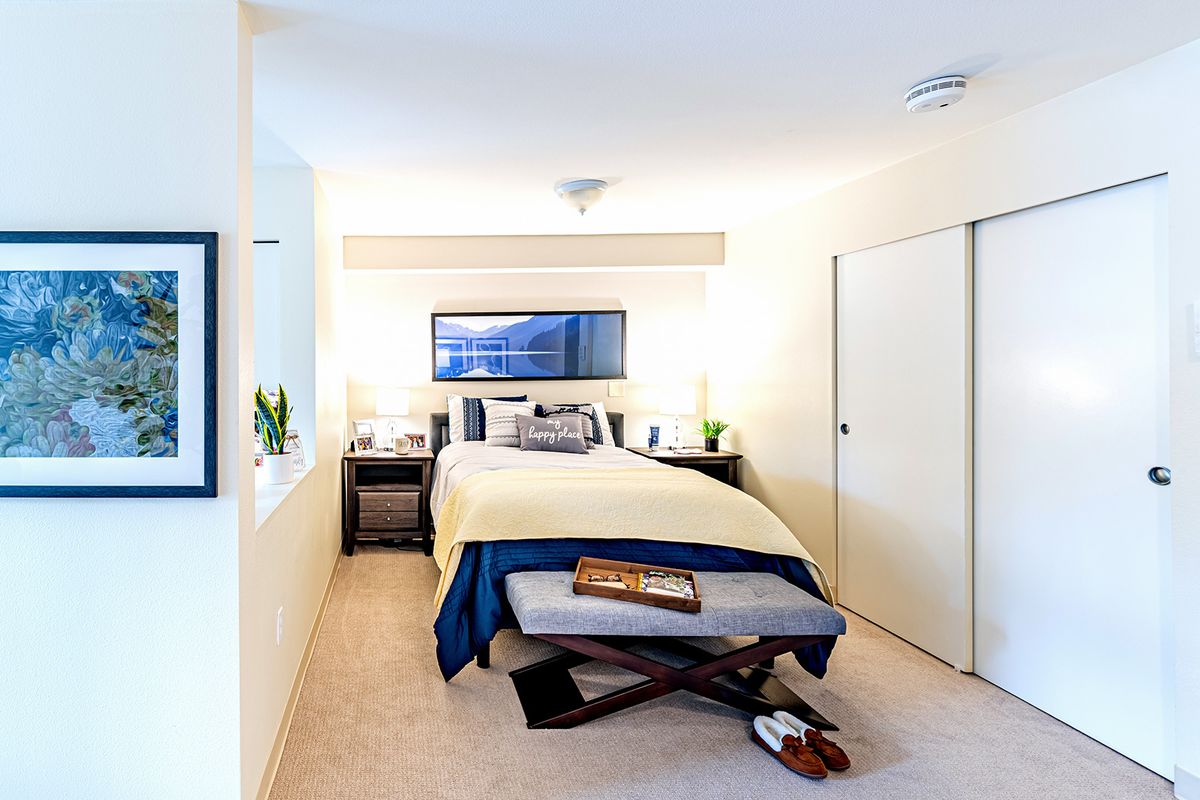 A modern and cozy bedroom with neutral colors and stylish decor.