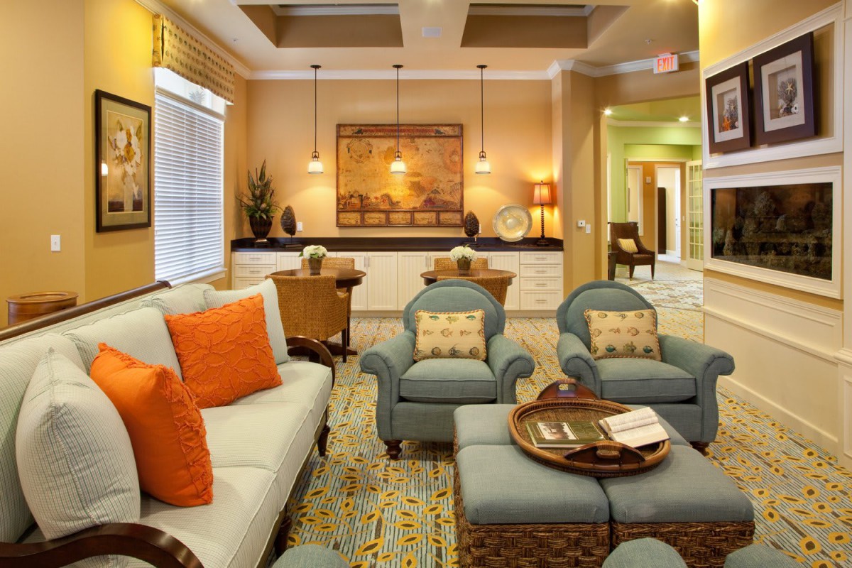 A cozy and elegantly decorated living room with comfortable seating and warm lighting.
