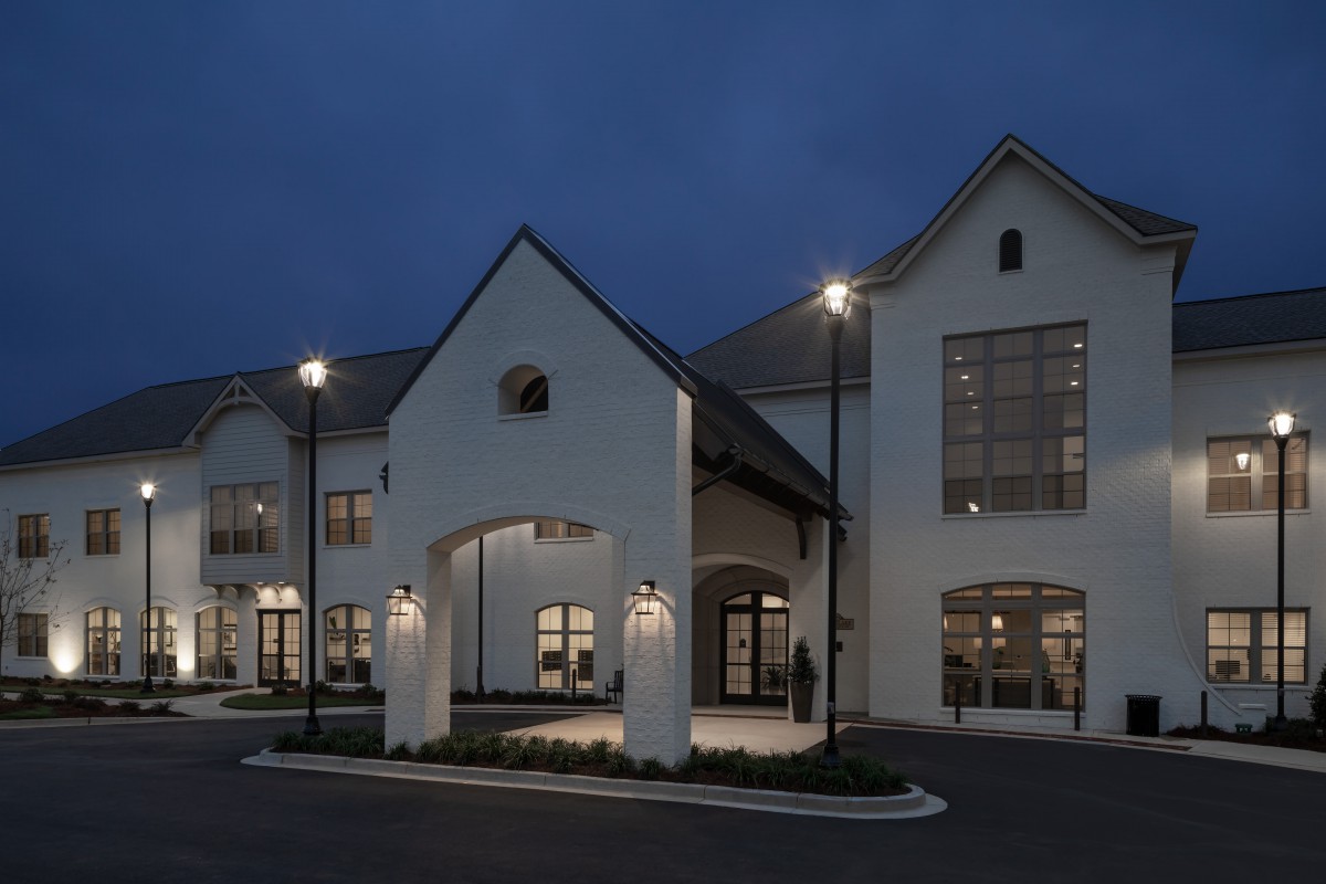 A modern building illuminated at night with exterior lights.