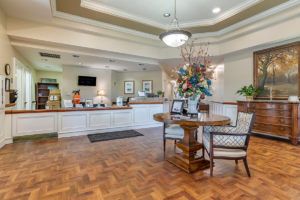 A well-decorated hotel lobby with a reception desk and seating area.