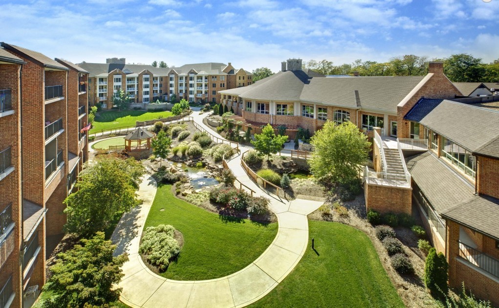 A scenic view of a residential complex with beautifully landscaped gardens and winding pathways.