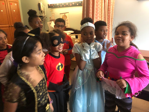 A group of children in colorful costumes enjoying a festive celebration.