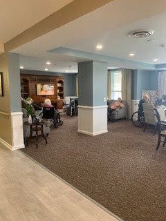 A cozy common area in a nursing home with comfortable seating for seniors.