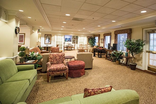 A cozy living room with assorted seating options and warm lighting.