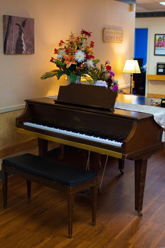 A beautifully arranged piano adorned with fresh flowers, set in a cozy interior space.