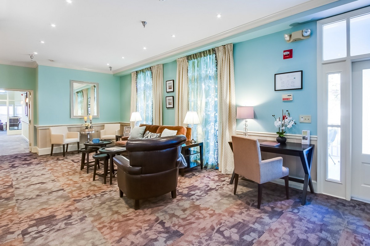 A cozy living room with blue walls, featuring comfortable seating and elegant decor.