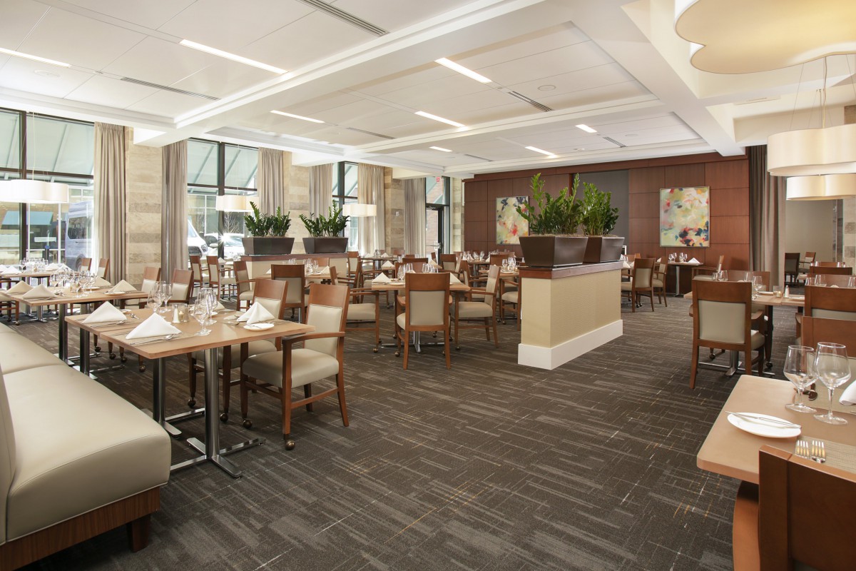 A modern restaurant interior with neatly arranged tables and chairs.