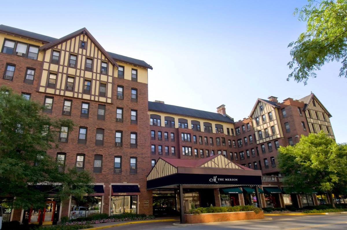 A brick hotel with a classic architectural design under a clear blue sky.