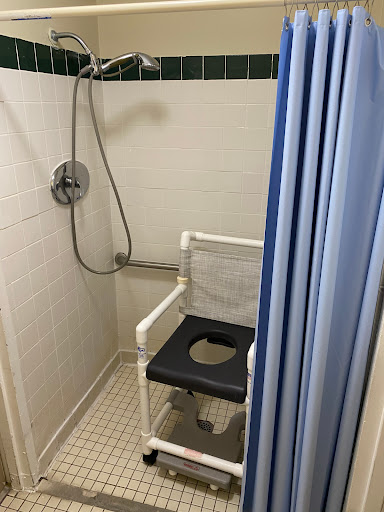 An accessible shower equipped with a shower chair for ease of use.