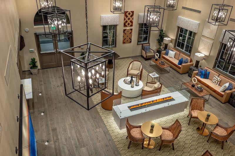 A modern lobby with stylish furniture and elegant lighting fixtures.