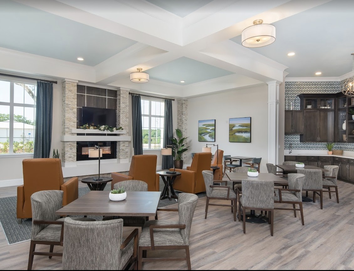 A modern living room interior with a cozy seating area, fireplace, and stylish decor.