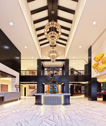 A luxurious hotel lobby featuring modern design elements and a grand chandelier.