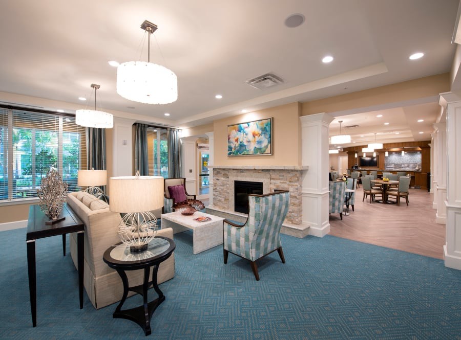A cozy, well-decorated living room featuring comfortable seating and a fireplace.