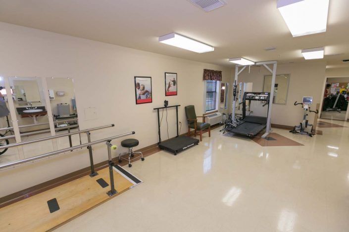 A well-equipped physical therapy room featuring various rehabilitation machines and equipment.