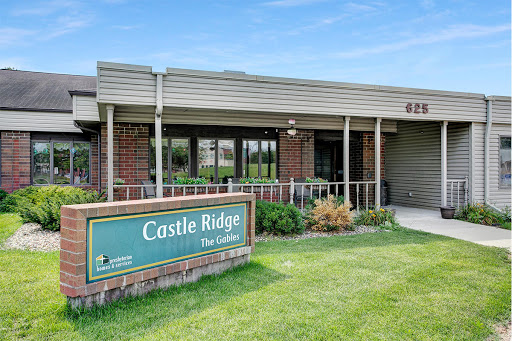 Entrance of Castle Ridge facility with a well-maintained lawn.