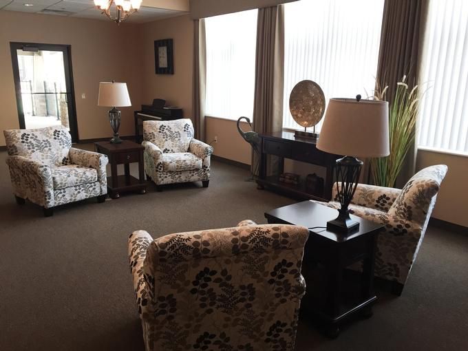 A cozy living room with patterned armchairs and soft lighting.