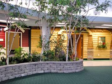 A vibrant indoor space featuring wooden accents and lush greenery, creating a calming environment.