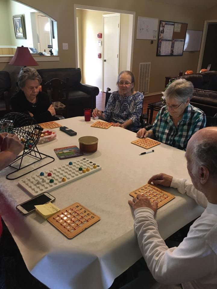 A group of seniors enjoying a game of bingo indoors.