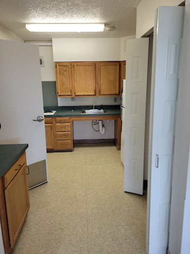 A spacious kitchen with wooden cabinets and a clean, open layout.