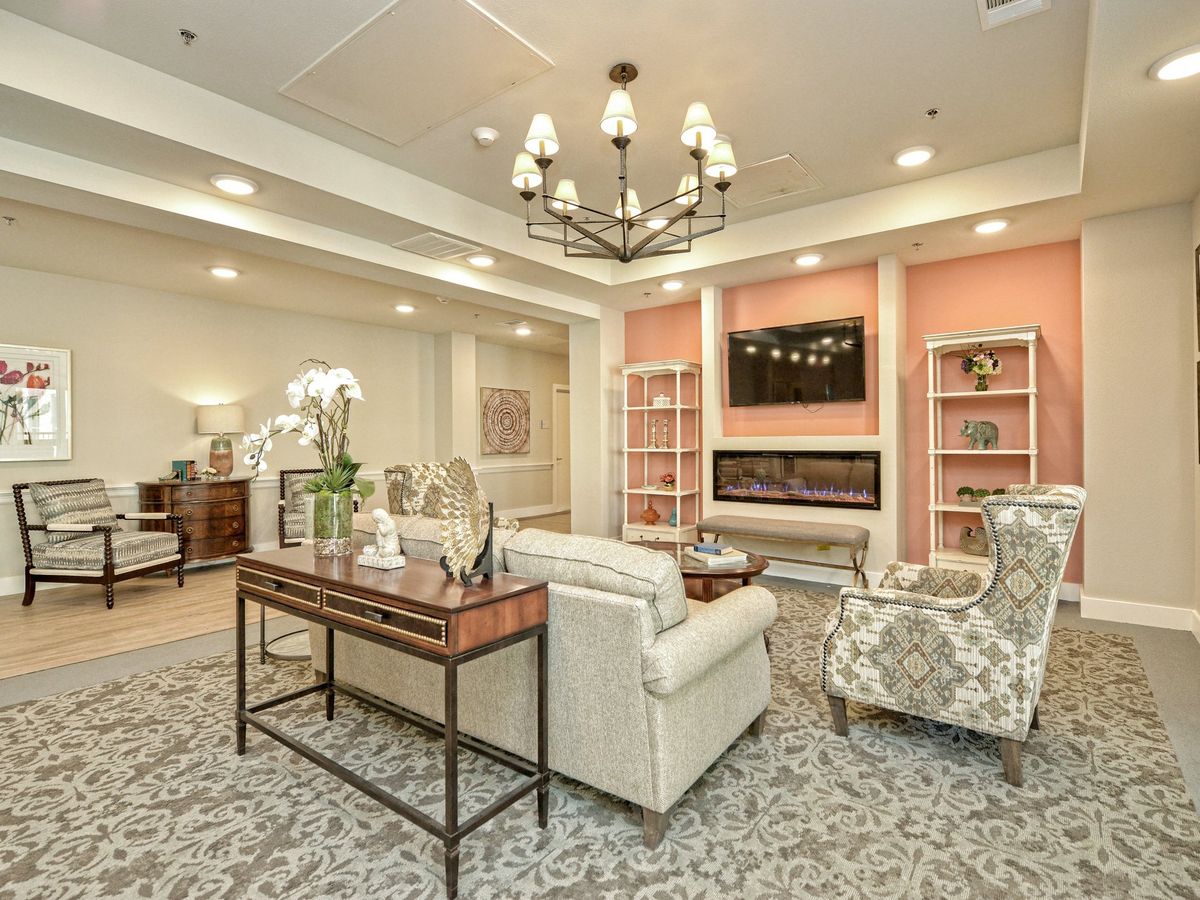 A cozy living room featuring elegant furniture and a warm fireplace.