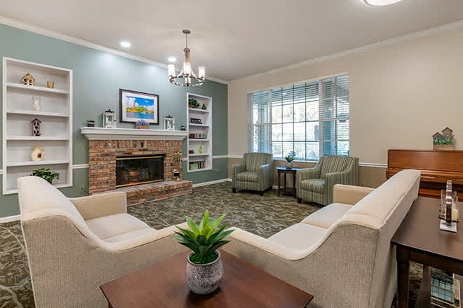 A cozy living room with a fireplace, comfortable seating, and tasteful decor.