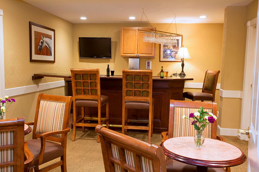 A cozy living room with a bar area and comfortable seating.