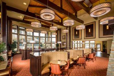 A warmly lit restaurant interior with elegant seating and stylish lighting fixtures.