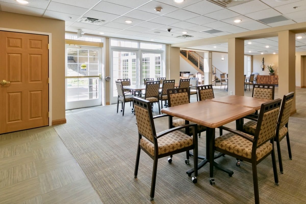 A spacious and modern dining area with natural lighting and comfortable seating.