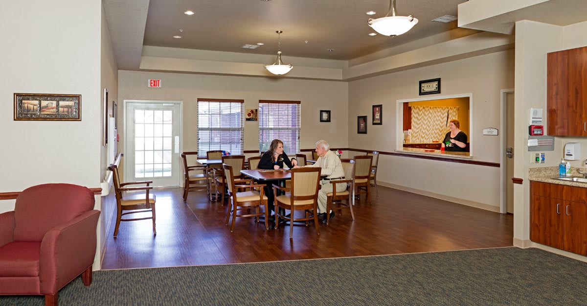 Two people having a conversation in a cozy dining area.